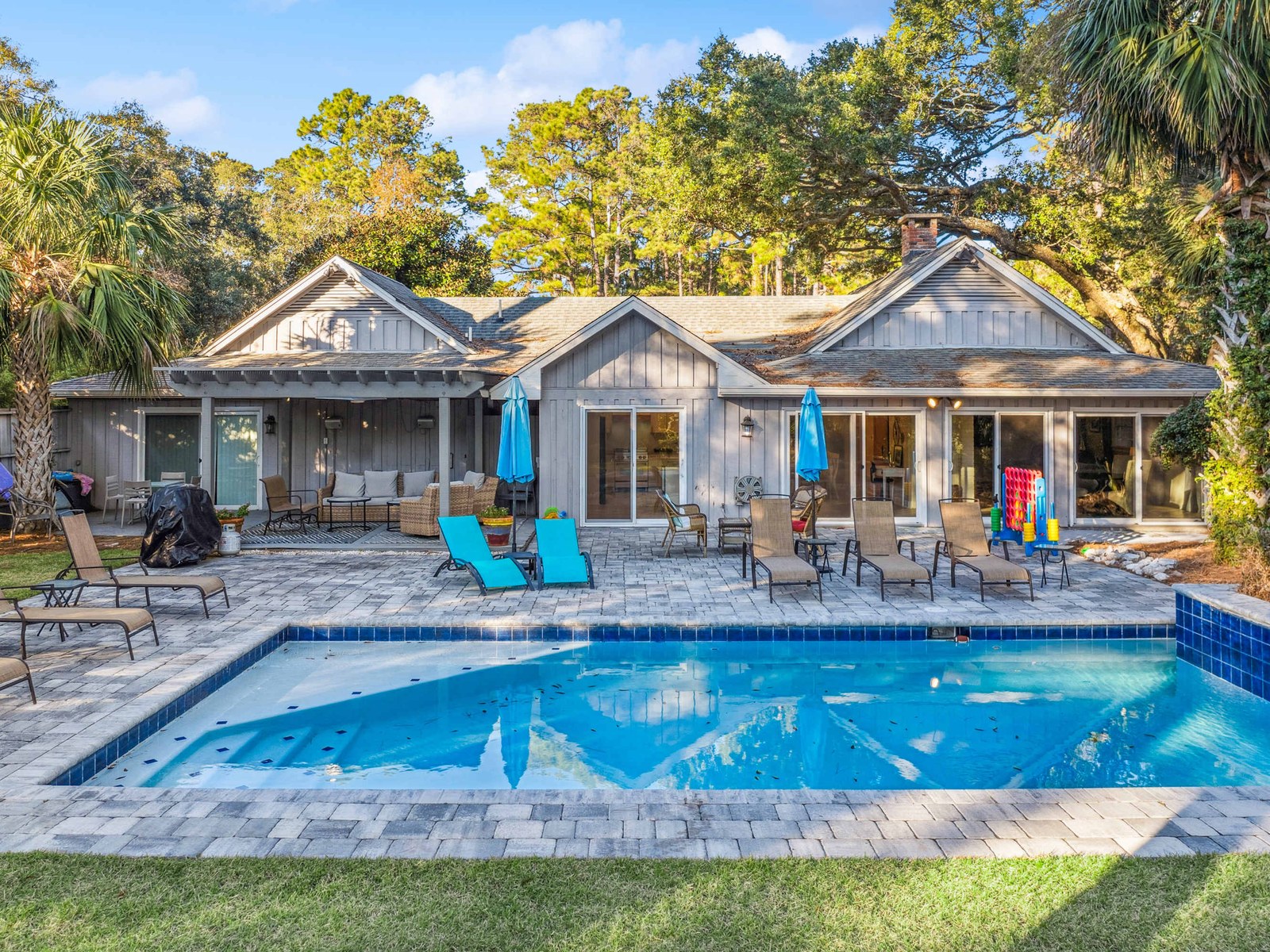 Hilton Head Island pool home among palms and live oaks